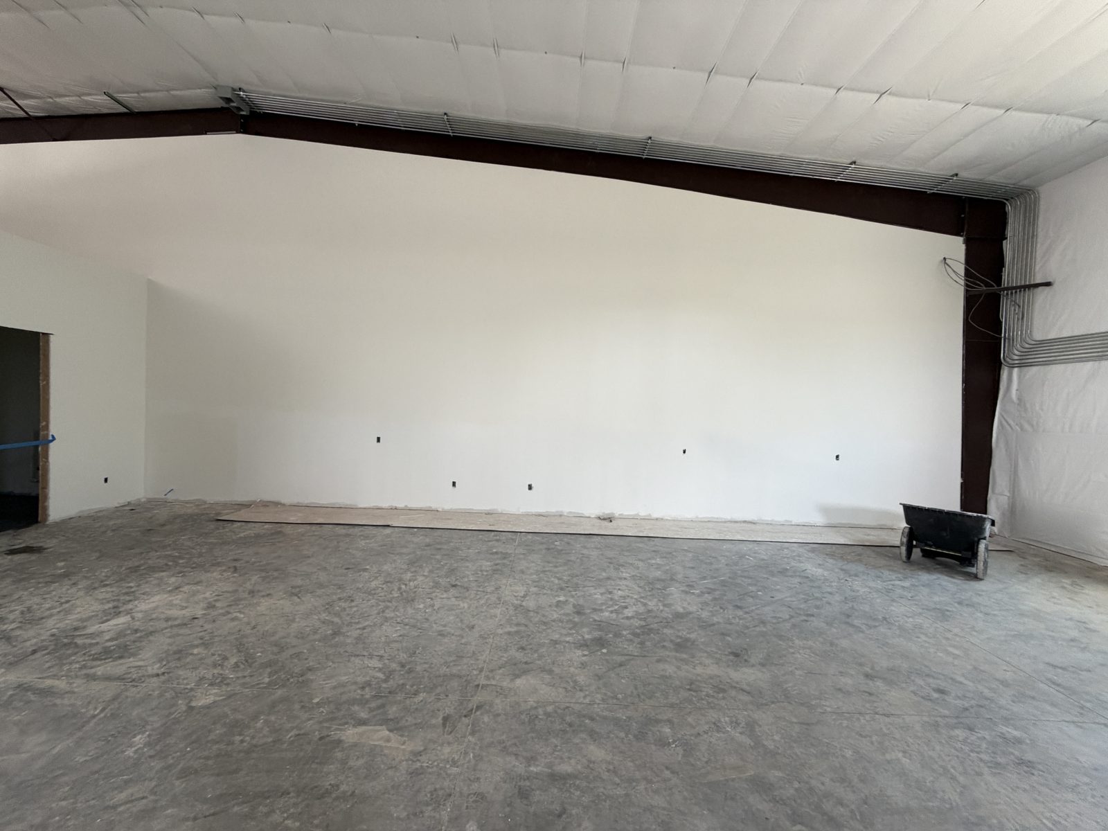 Insulated metal building interior with red-iron columns, Grand Prairie Texas